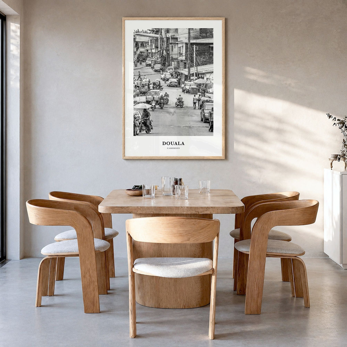 Douala Classic Poster in a natural wood frame, hanging in a dining room
