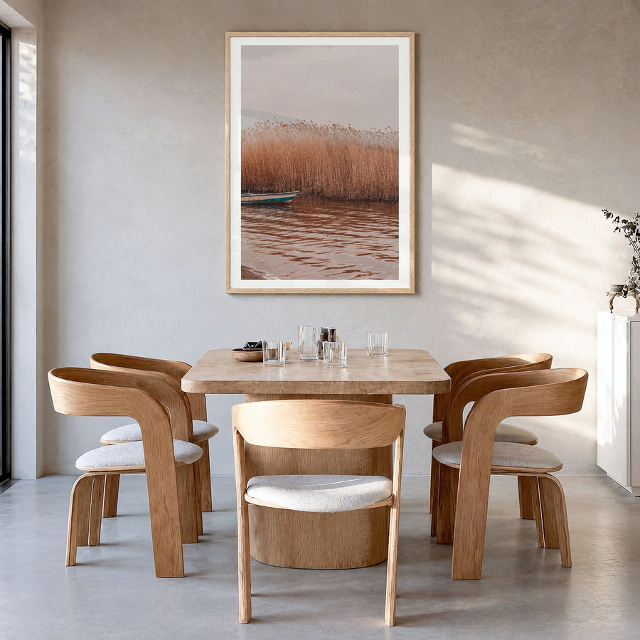 Dry Reed Lake Photo Poster in a natural wood frame, hanging in a dining room, white border