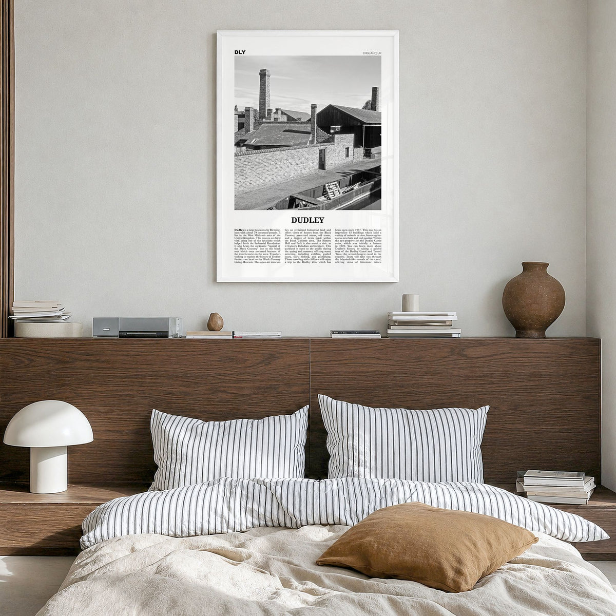 Dudley Newspaper Poster in a white wood frame, hanging in a bedroom