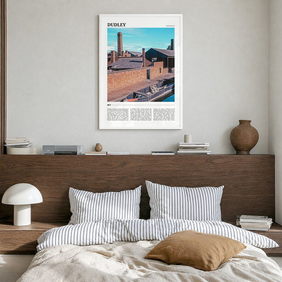 Dudley Travel Poster in a white wood frame, hanging in a bedroom