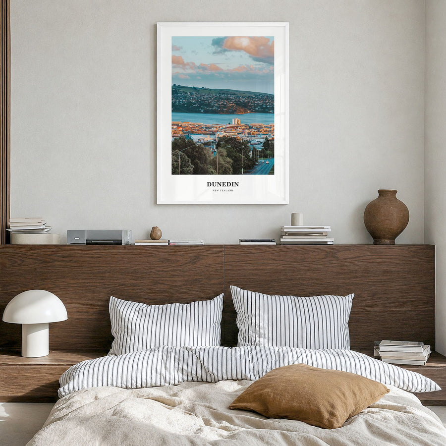 Dunedin Classic No 1 Poster in a white wood frame, hanging in a bedroom