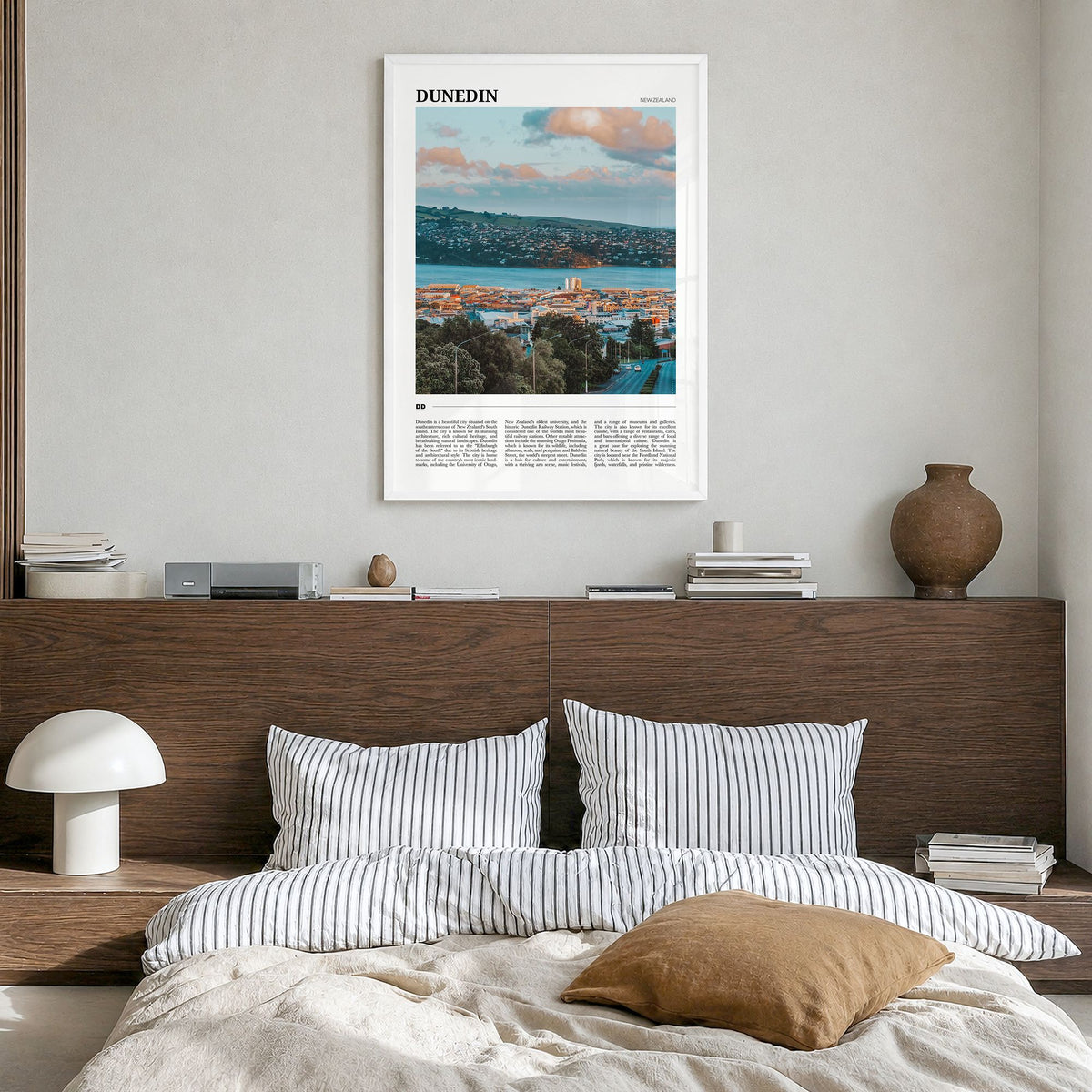 Dunedin Travel No 1 Poster in a white wood frame, hanging in a bedroom