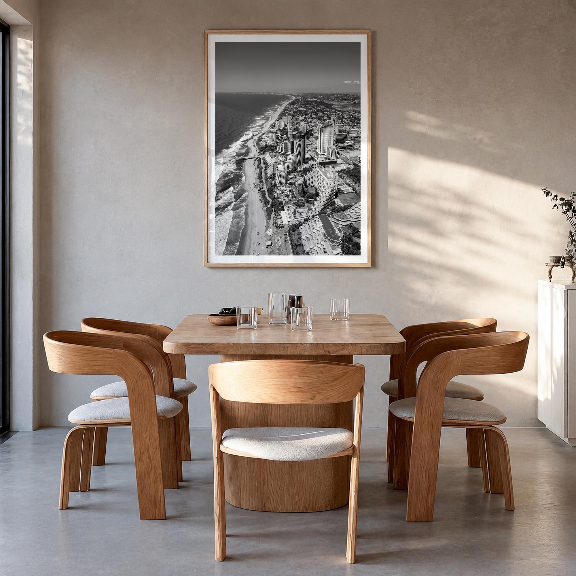 Durban black & white photo poster of South Africa – vertical wall art in natural wood frame with white border, hanging on wal