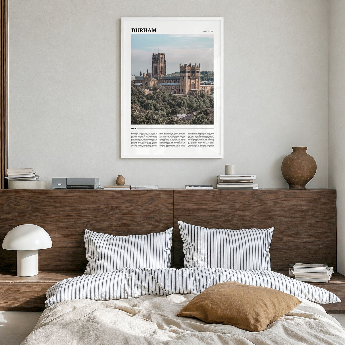 Durham, England Travel Poster in a white wood frame, hanging in a bedroom