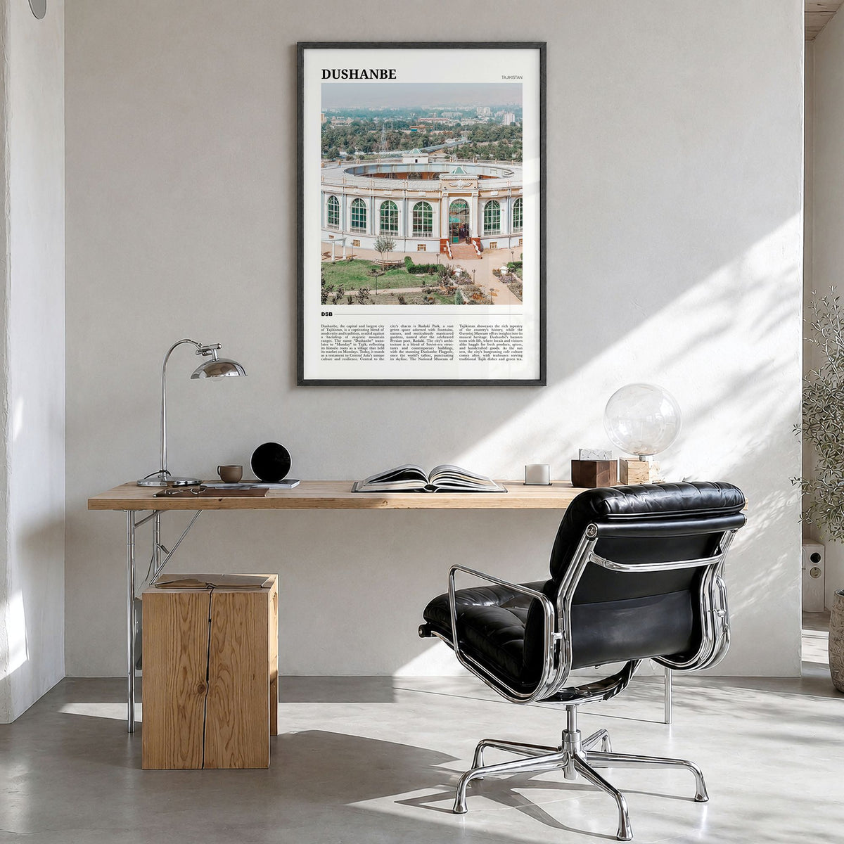 Dushanbe Travel Poster in a black wood frame, hanging in a bright home office