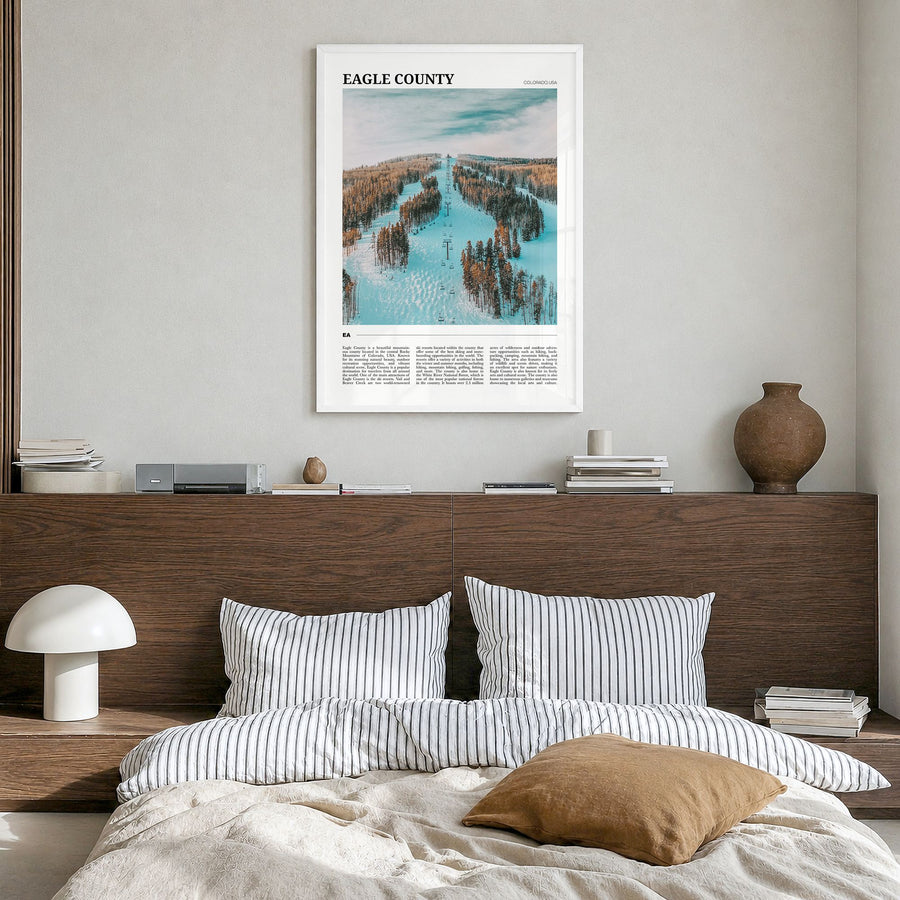 Eagle County Travel Poster in a white wood frame, hanging in a bedroom