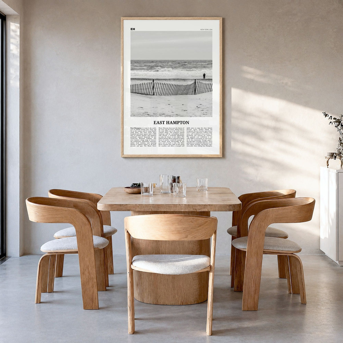 East Hampton Newspaper Poster in a natural wood frame, hanging in a dining room