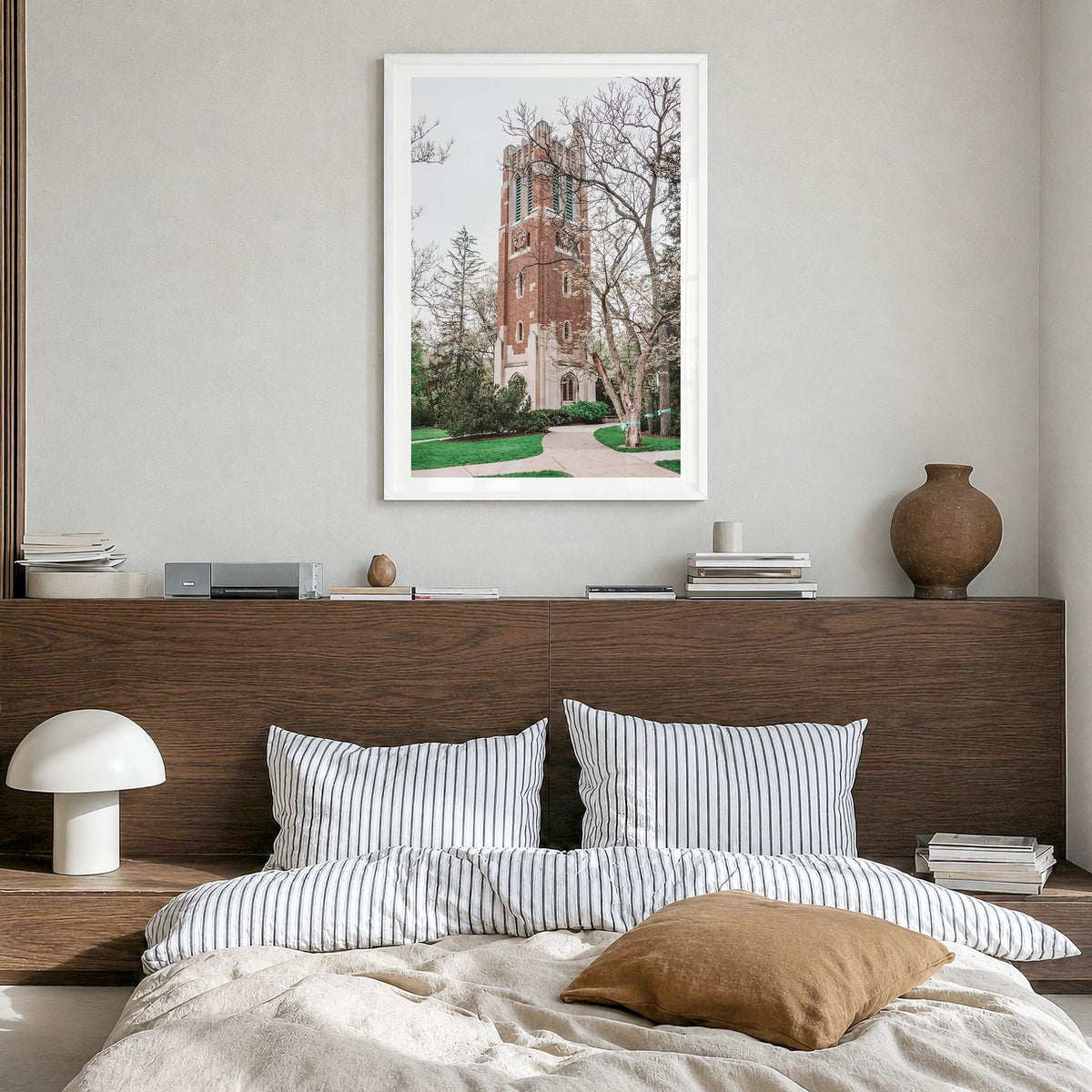 East Lansing Photo Poster in a white wood frame, hanging in a bedroom, white border