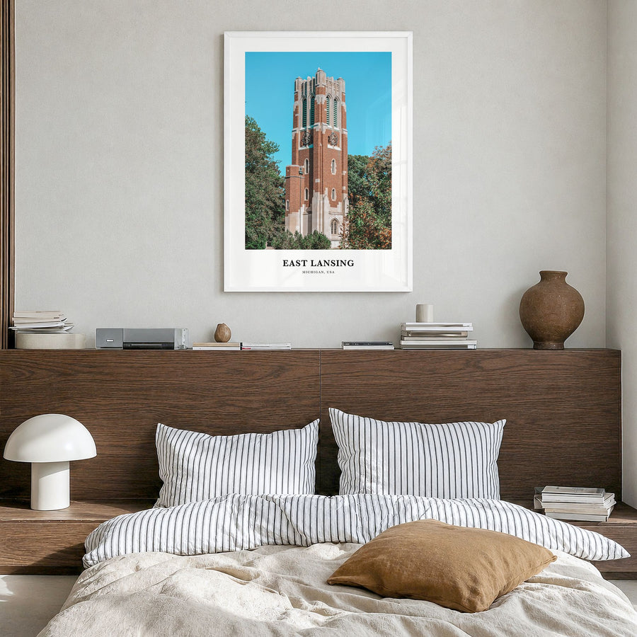 East Lansing Classic Poster in a white wood frame, hanging in a bedroom
