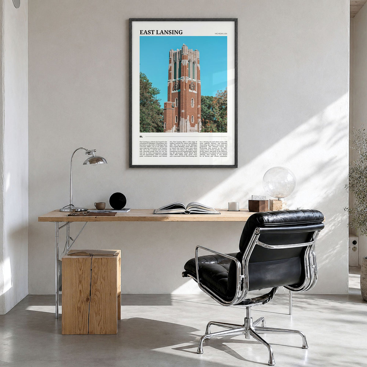 East Lansing Travel Poster in a black wood frame, hanging in a bright home office