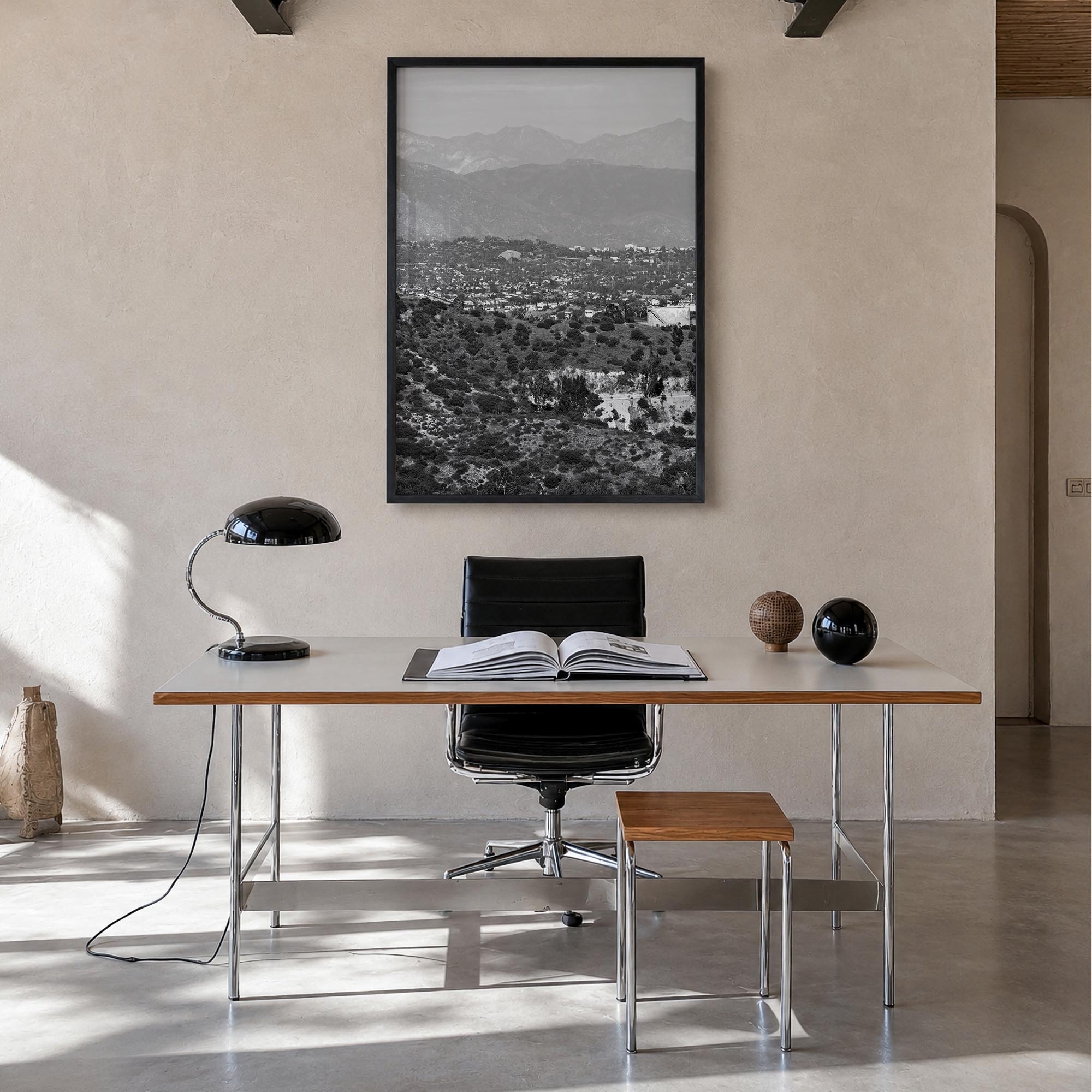 East Los Angeles black & white photo poster of Los Angeles, California – vertical wall art in black wood frame, hanging on wa