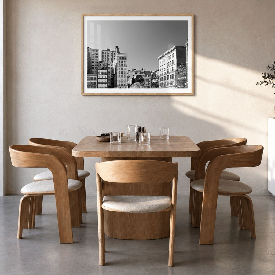 East Village, New York Photo Poster in a natural wood frame, hanging in a dining room, white border