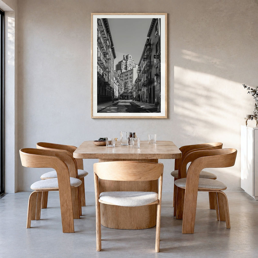 East Village, New York Photo Poster in a natural wood frame, hanging in a dining room, white border