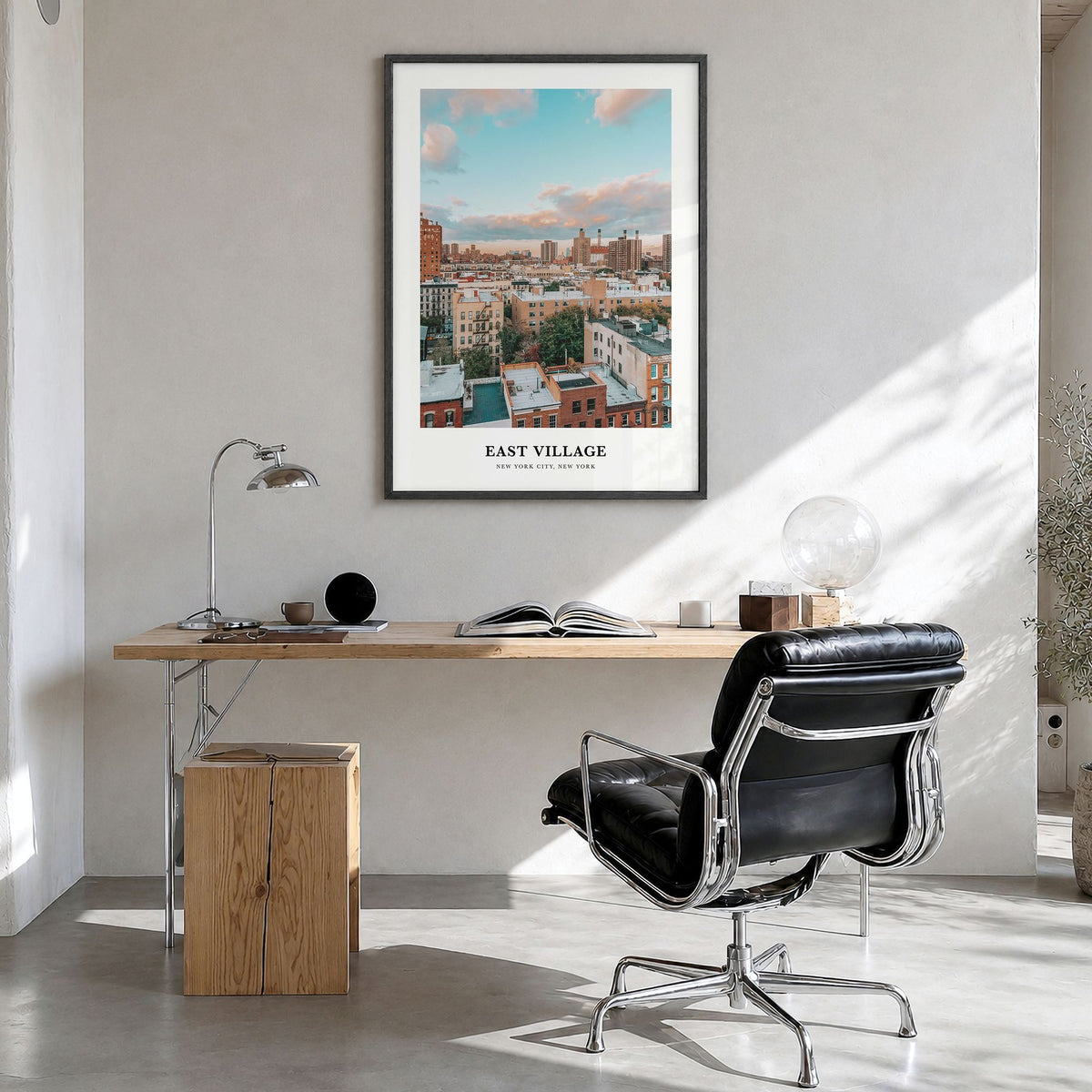 East Village, New York Classic Poster in a black wood frame, hanging in a bright home office