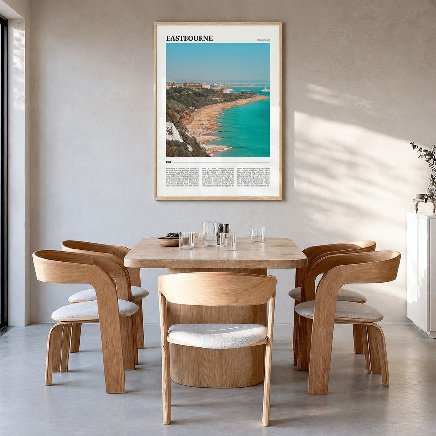 Eastbourne Travel Poster in a natural wood frame, hanging in a dining room