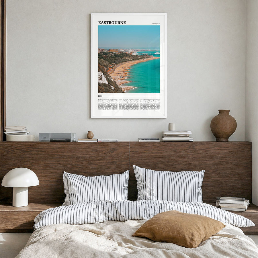 Eastbourne Travel Poster in a white wood frame, hanging in a bedroom