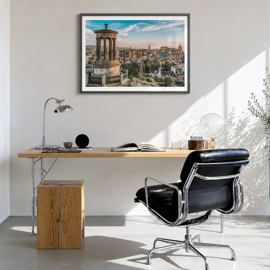 Edinburgh Photo Poster in a black wood frame, hanging in a bright home office, white border