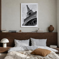 Eiffel Tower black & white photo poster of France – vertical wall art in white wood frame with white border, hanging on wall