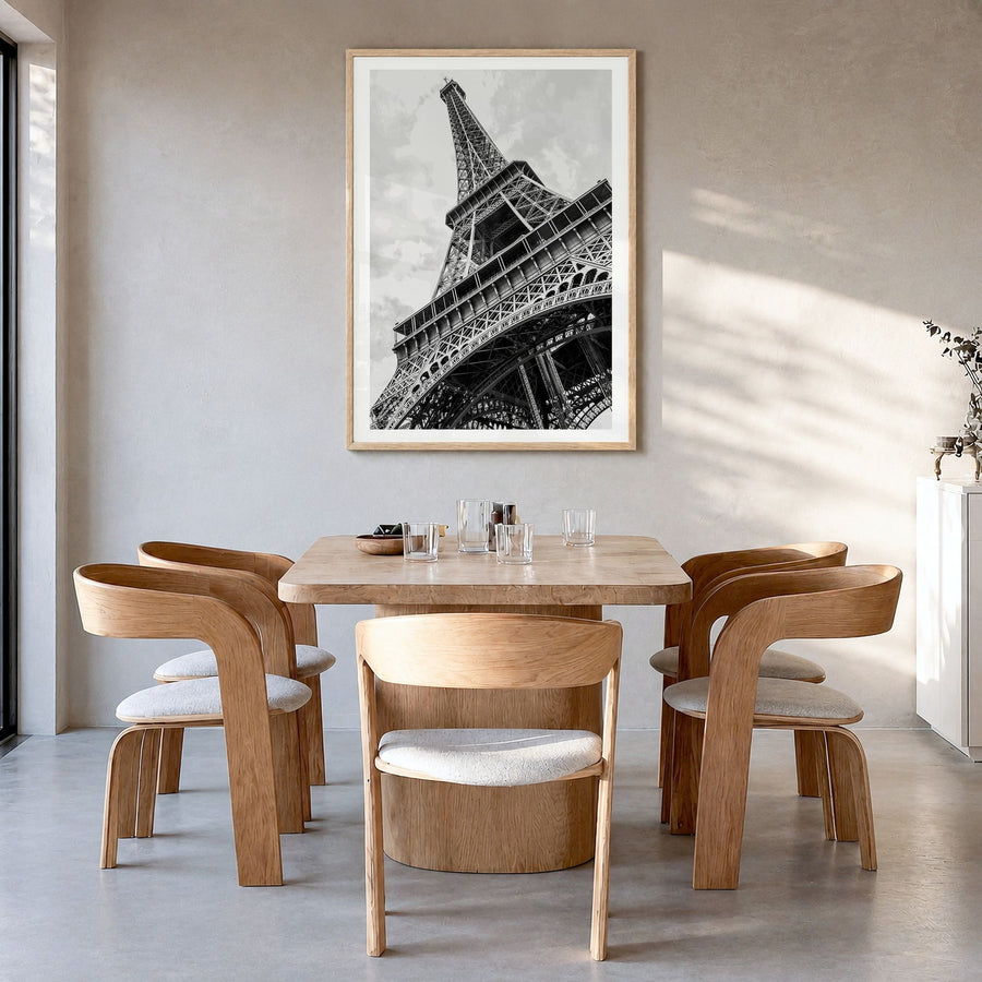Eiffel Tower Photo Poster in a natural wood frame, hanging in a dining room, white border