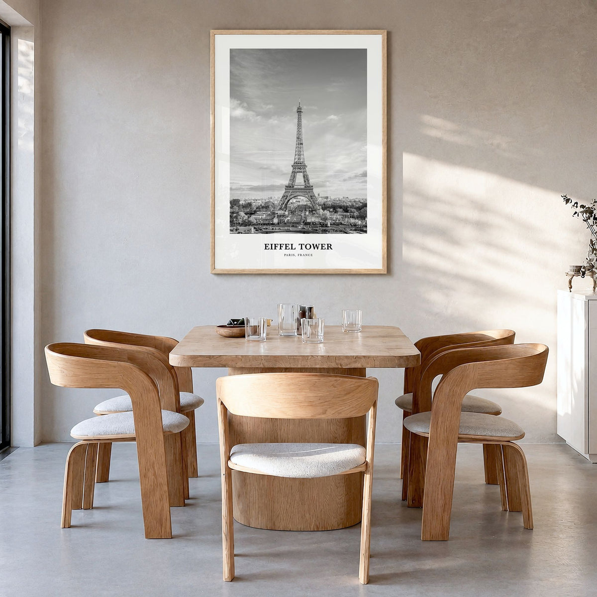 Eiffel Tower Classic Poster in a natural wood frame, hanging in a dining room