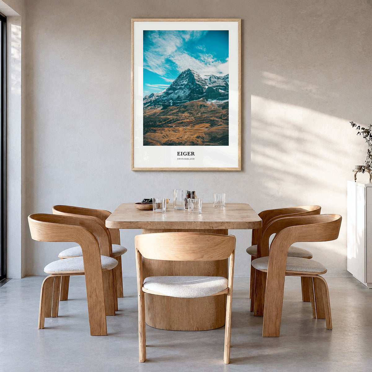 Eiger Classic Poster in a natural wood frame, hanging in a dining room