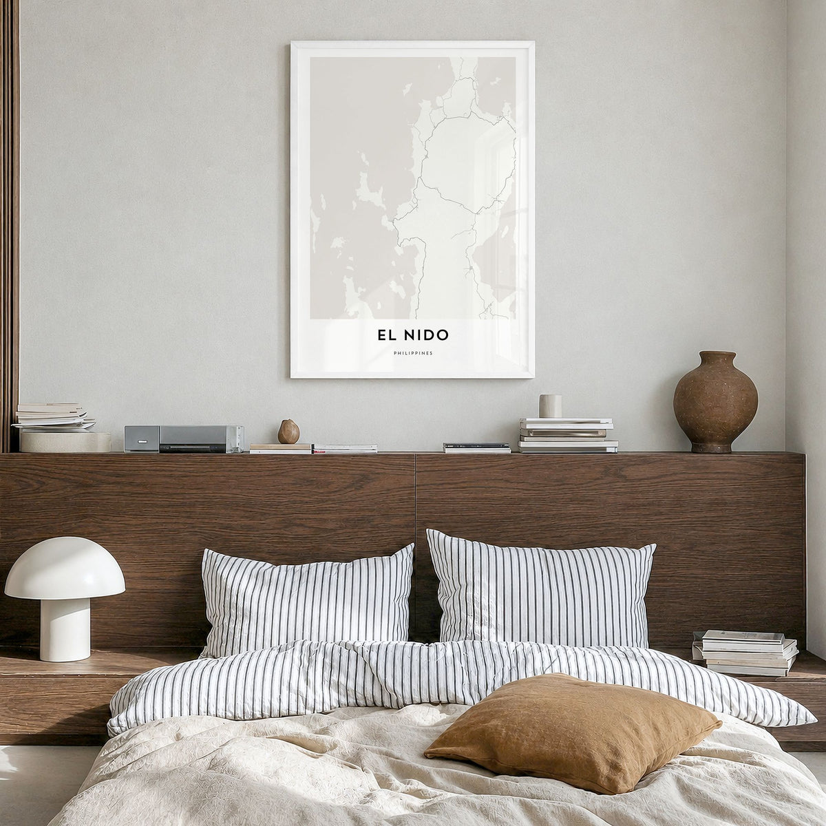 El Nido Map Poster in a white wood frame, hanging in a bedroom