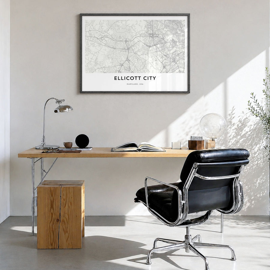 Ellicott City Map Poster in a black wood frame, hanging in a bright home office