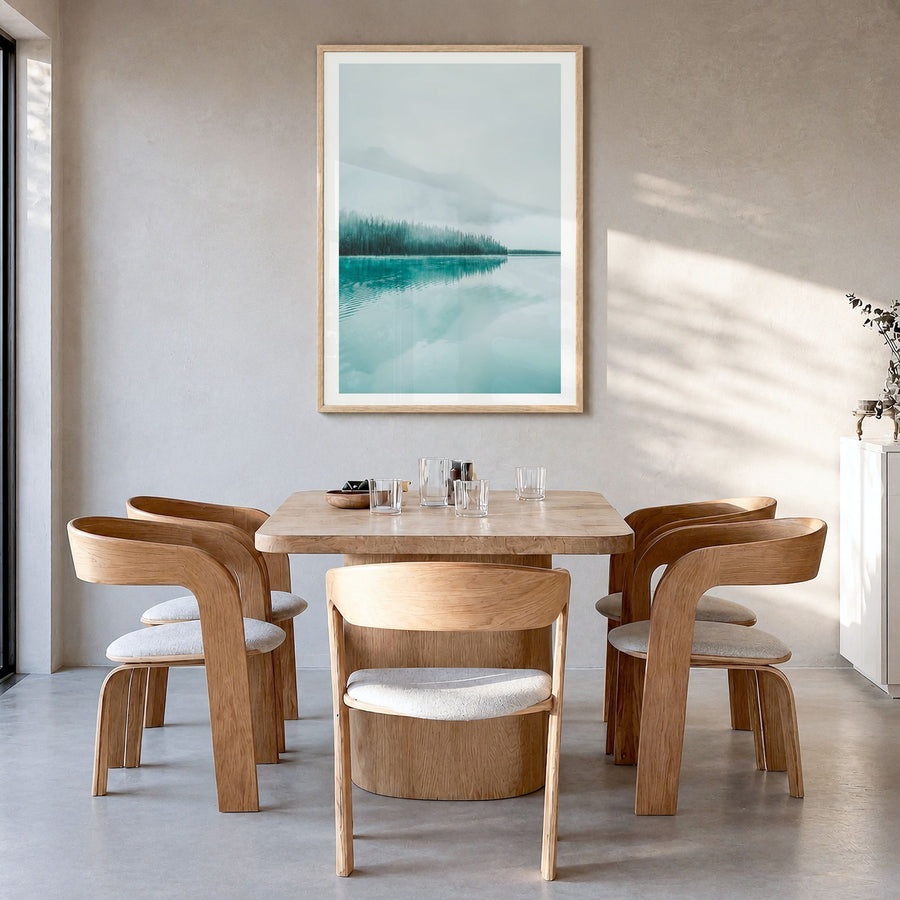 Emerald Lake Photo Poster in a natural wood frame, hanging in a dining room, white border