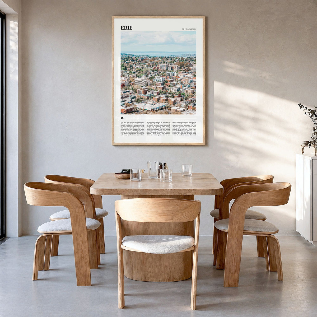 Erie Travel Poster in a natural wood frame, hanging in a dining room