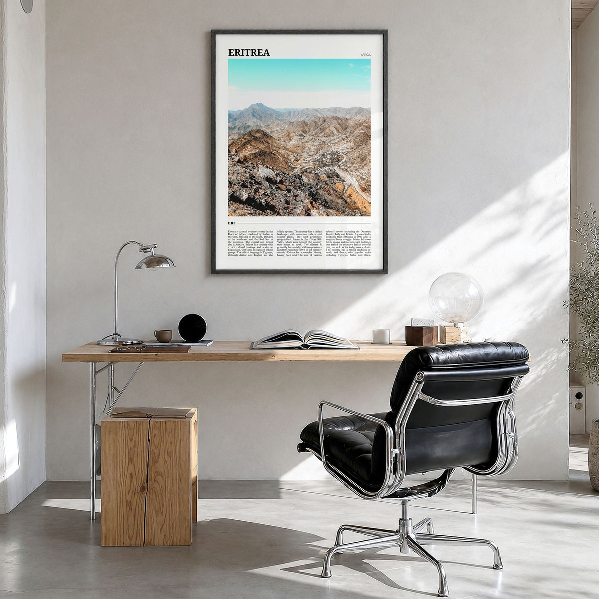 Eritrea Travel Poster in a black wood frame, hanging in a bright home office