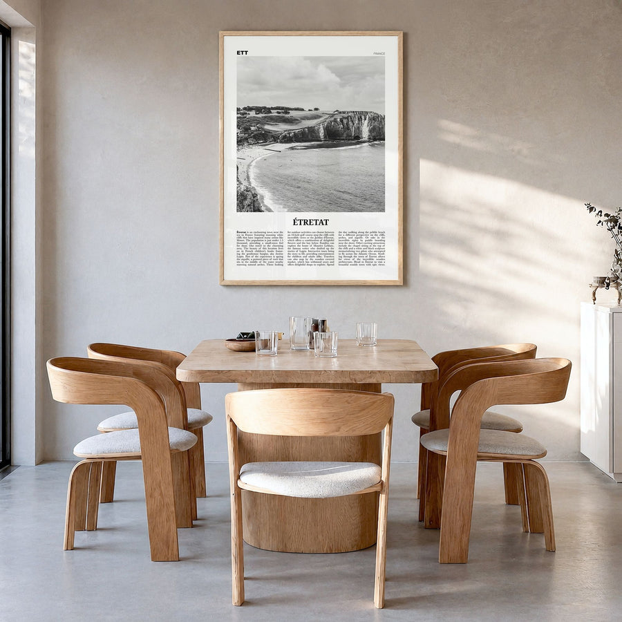 Étretat Newspaper Poster in a natural wood frame, hanging in a dining room