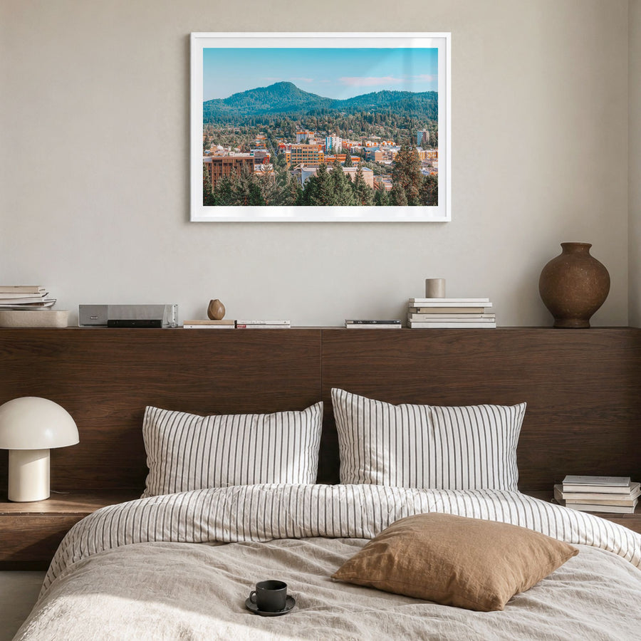 Eugene Photo Poster in a white wood frame, hanging in a bedroom, white border