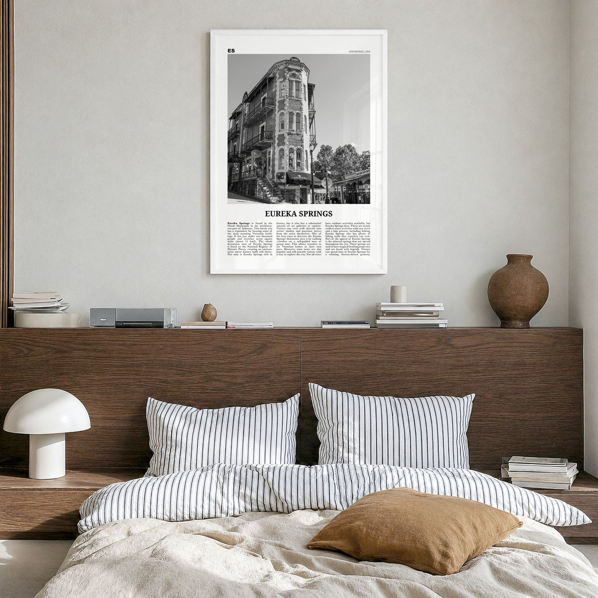 Eureka Springs Newspaper Poster in a white wood frame, hanging in a bedroom