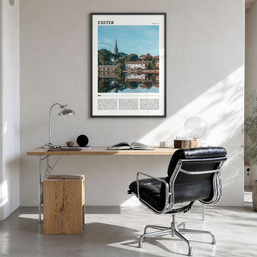 Exeter Travel Poster in a black wood frame, hanging in a bright home office