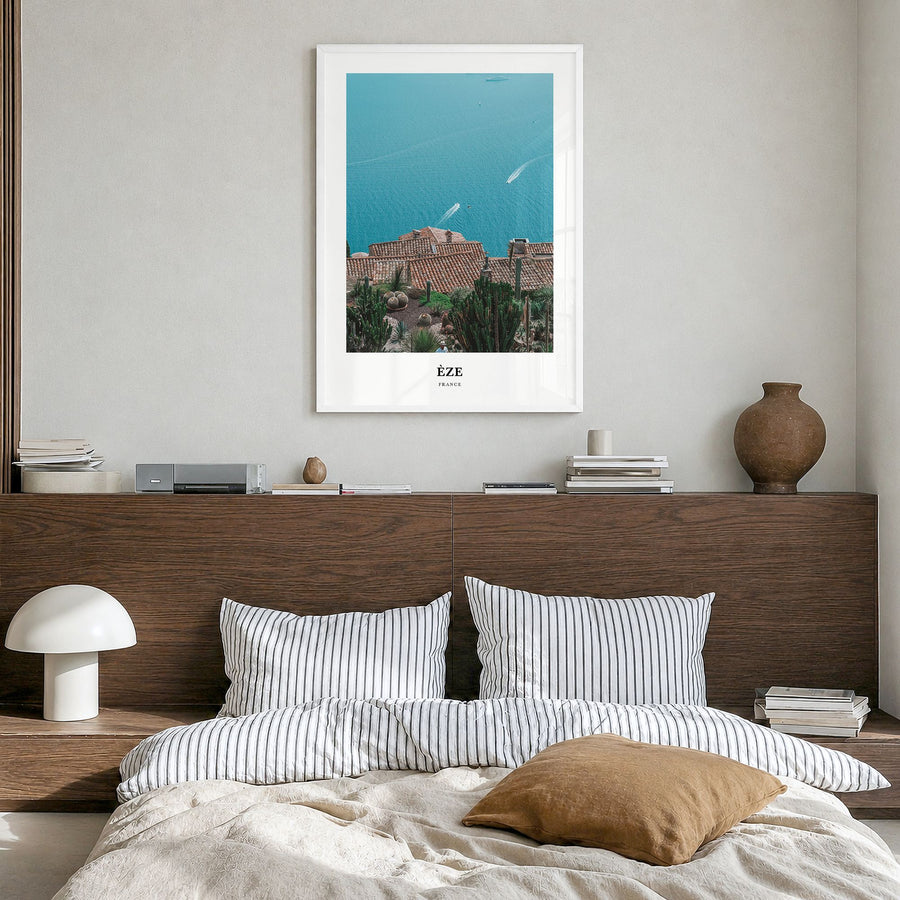 Èze Classic Poster in a white wood frame, hanging in a bedroom