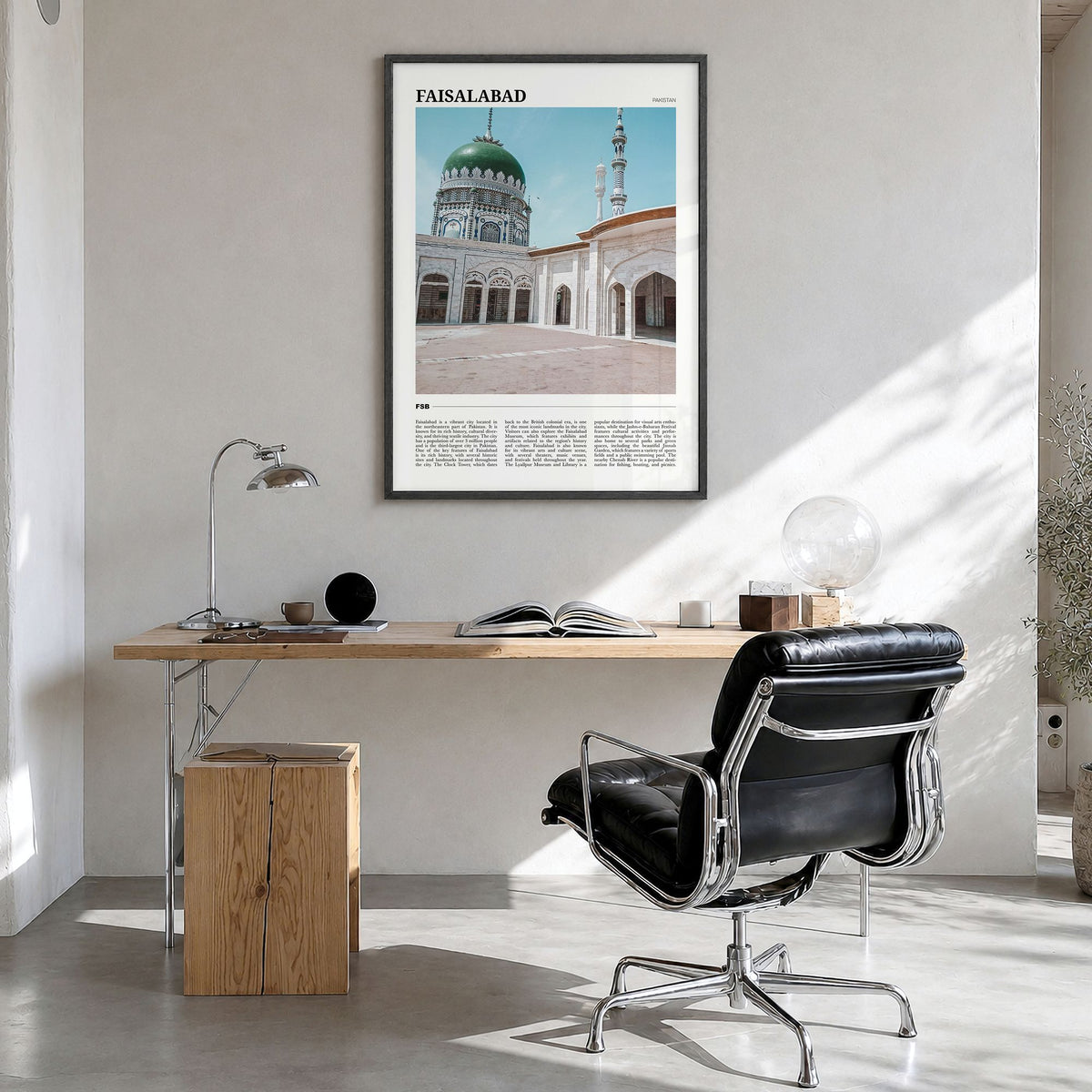 Faisalabad Travel Poster in a black wood frame, hanging in a bright home office
