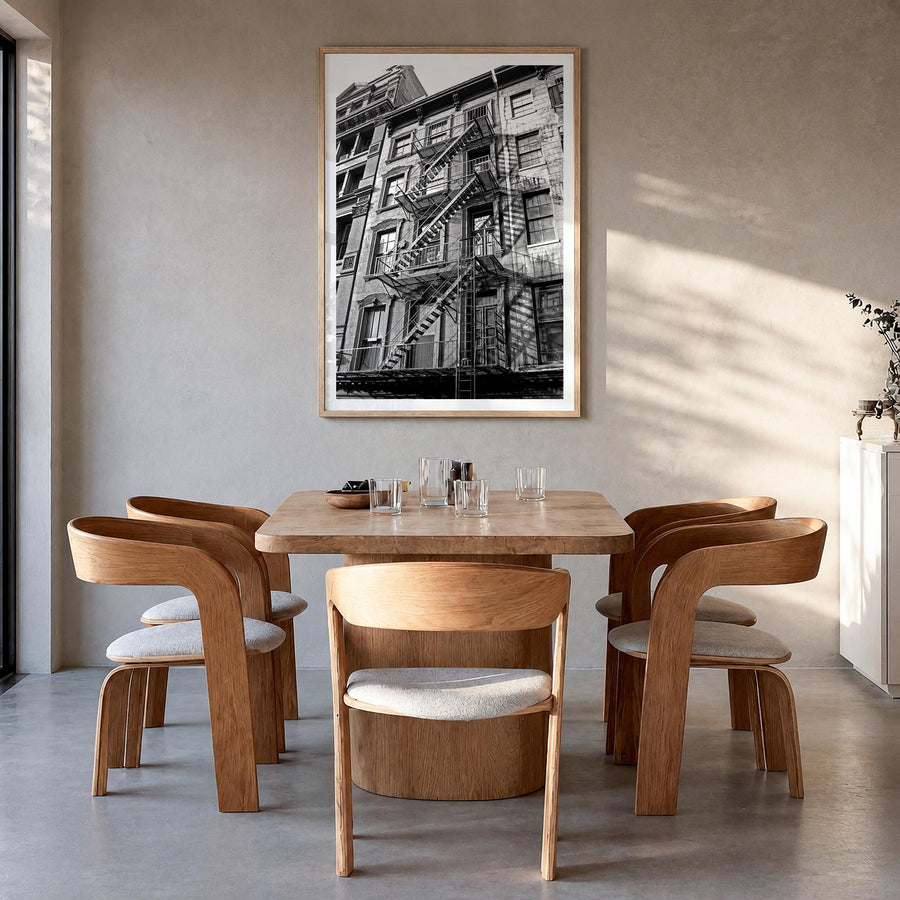 Fire Escapes no. 1 black & white photo poster – vertical wall art in natural wood frame with white border, hanging on wall