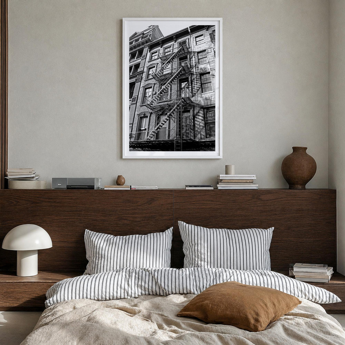 Fire Escapes no. 1 black & white photo poster – vertical wall art in white wood frame with white border, hanging on wall
