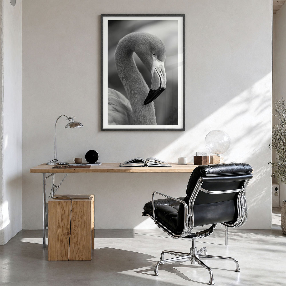 Flamingo Photo Poster in a black wood frame, hanging in a bright home office, white border