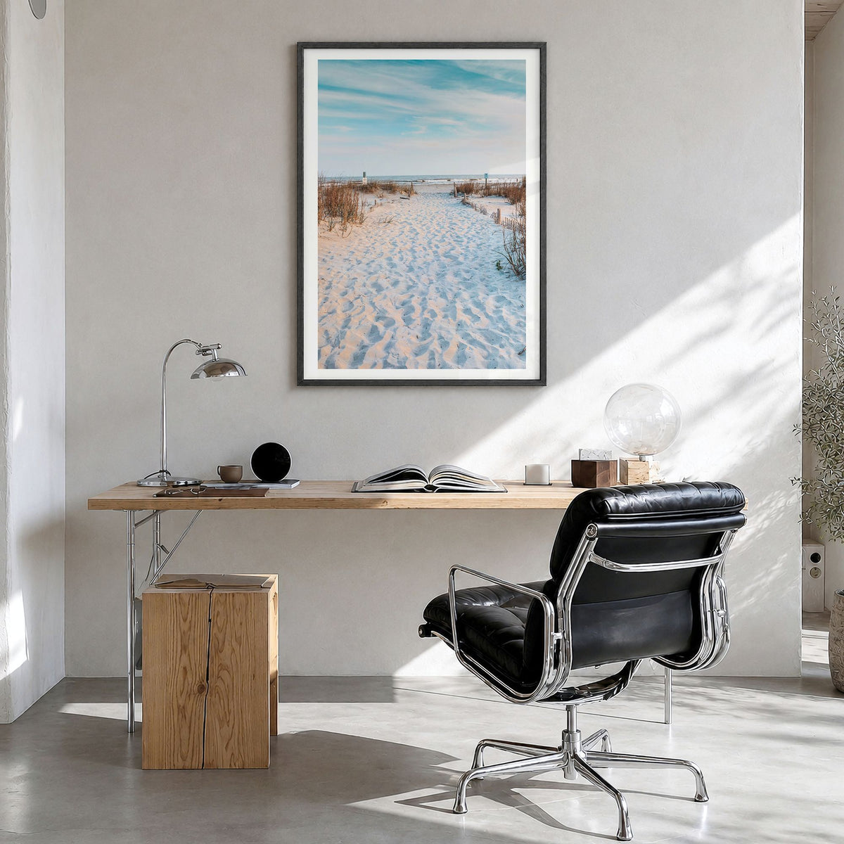 Folly Beach Photo Poster in a black wood frame, hanging in a bright home office, white border