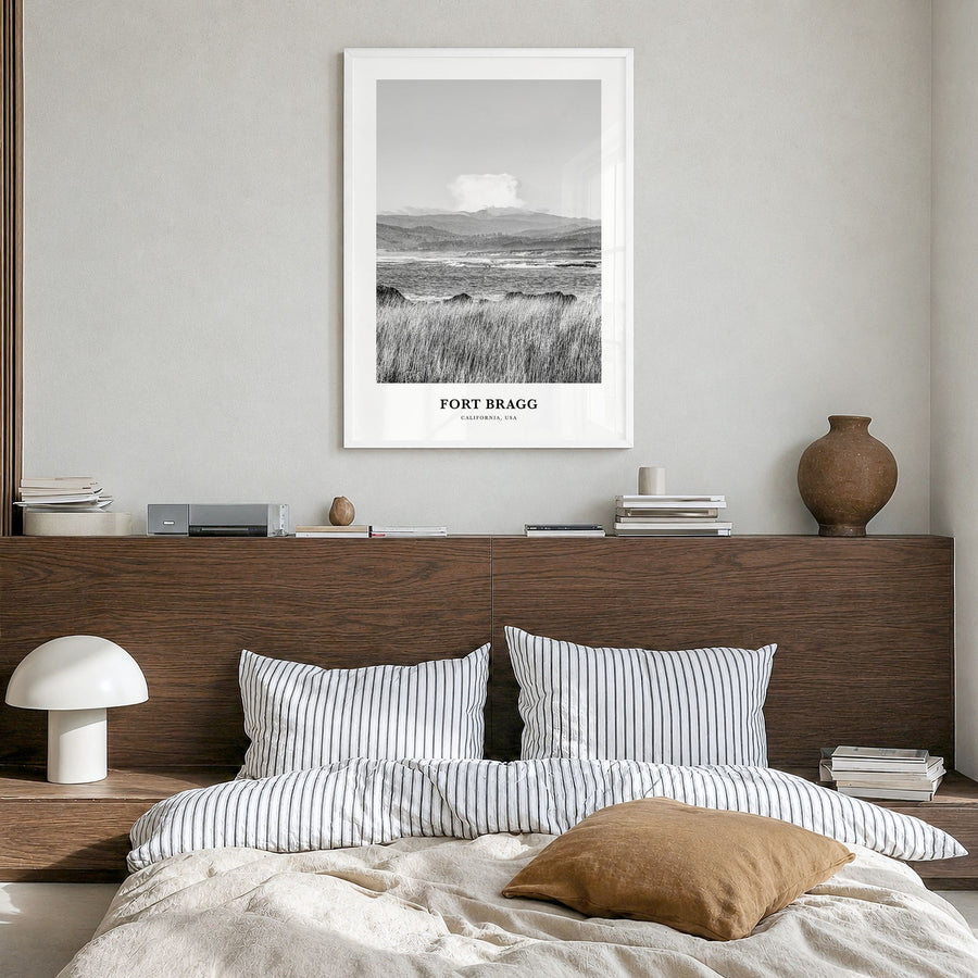 Fort Bragg Classic Poster in a white wood frame, hanging in a bedroom