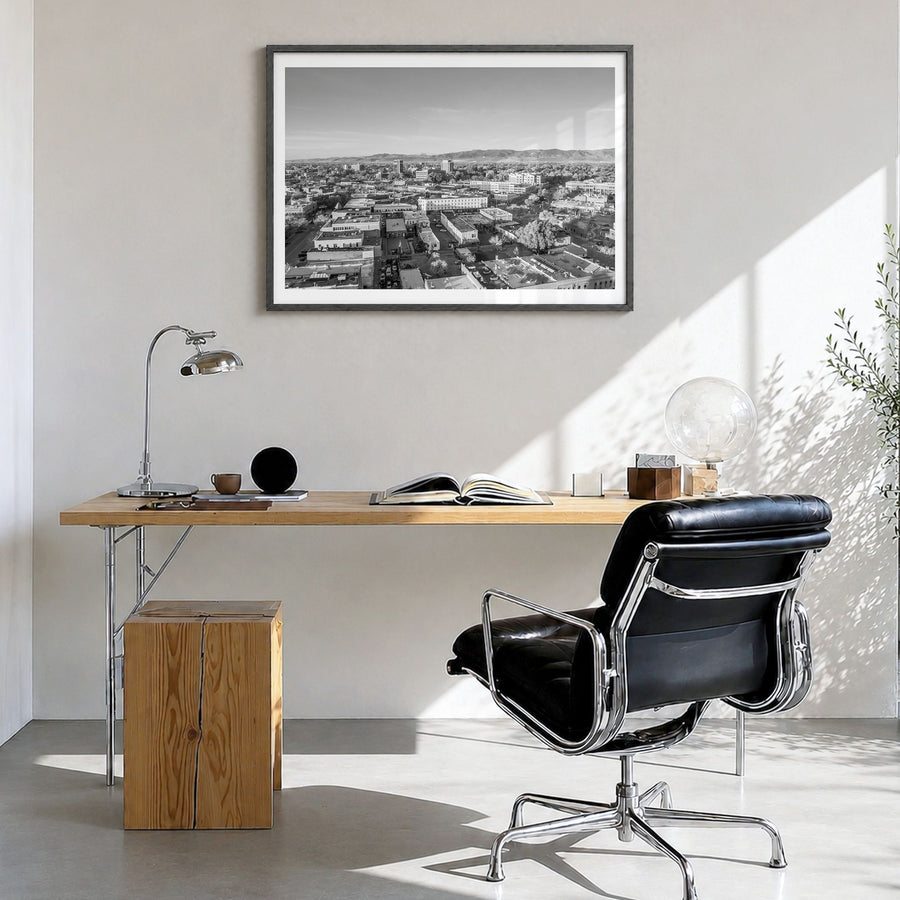 Fort Collins Photo Poster in a black wood frame, hanging in a bright home office, white border