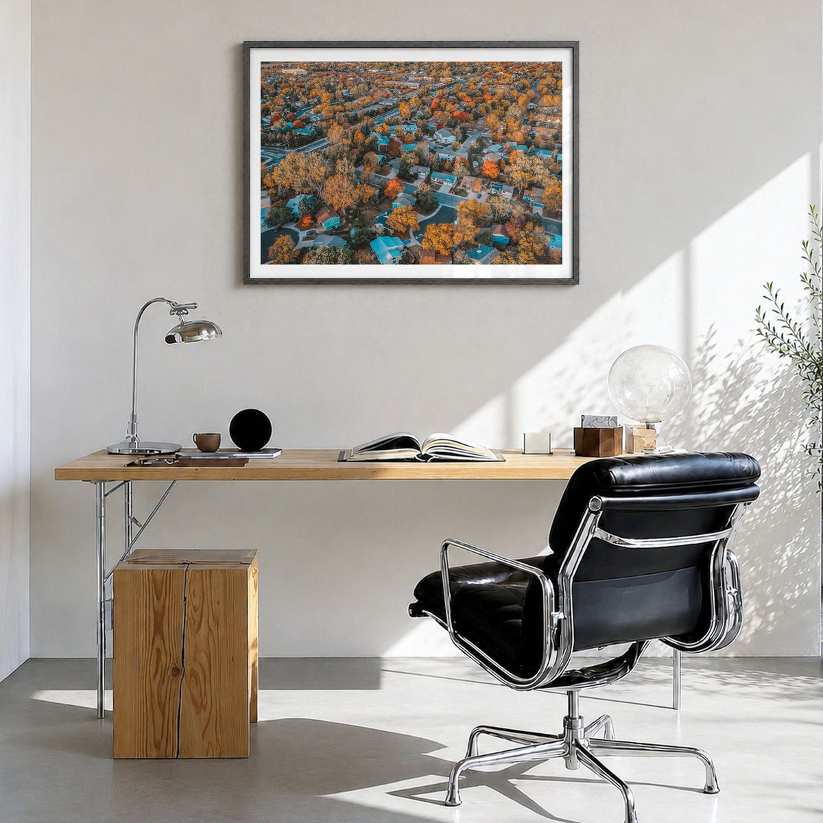 Fort Collins Photo Poster in a black wood frame, hanging in a bright home office, white border