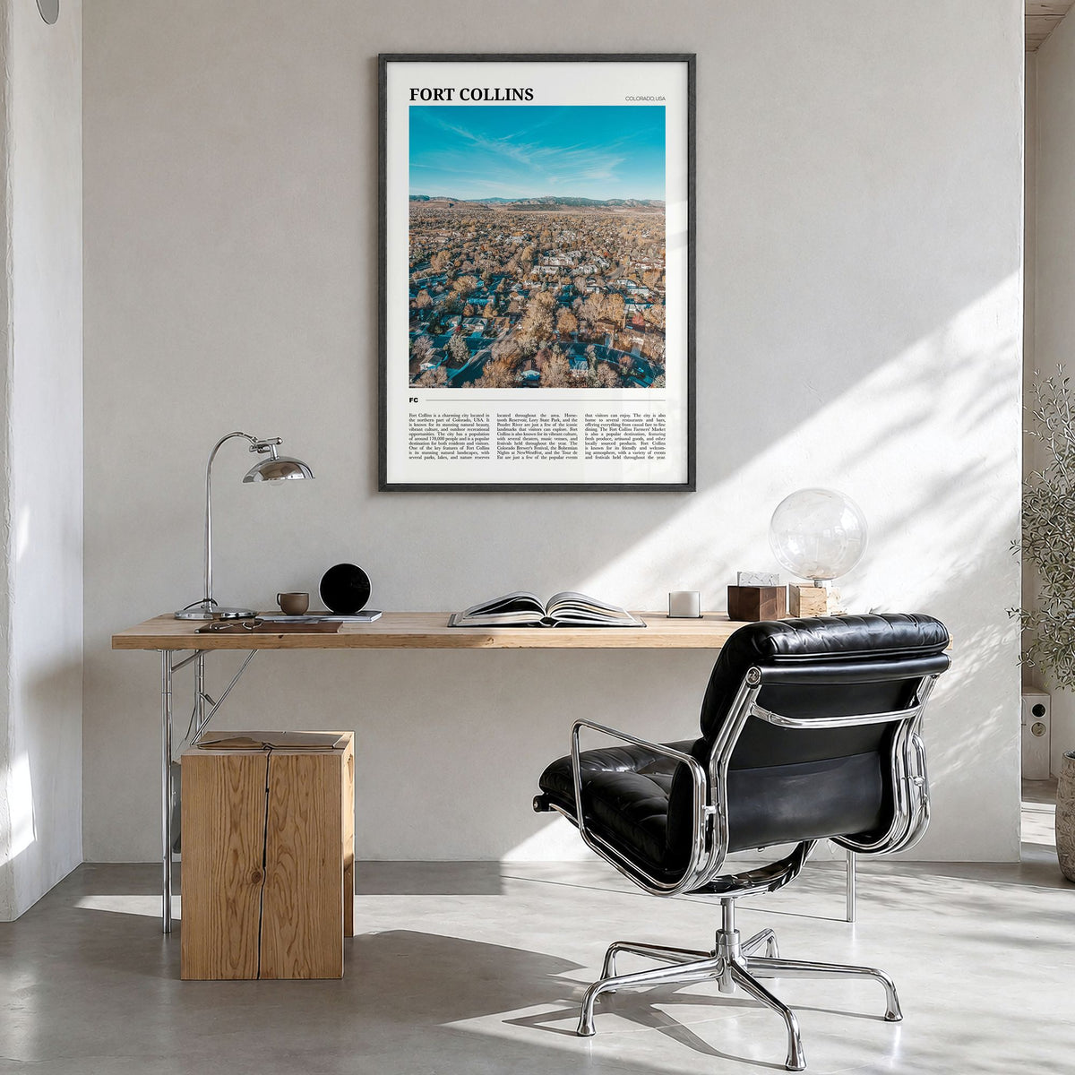 Fort Collins Travel Poster in a black wood frame, hanging in a bright home office