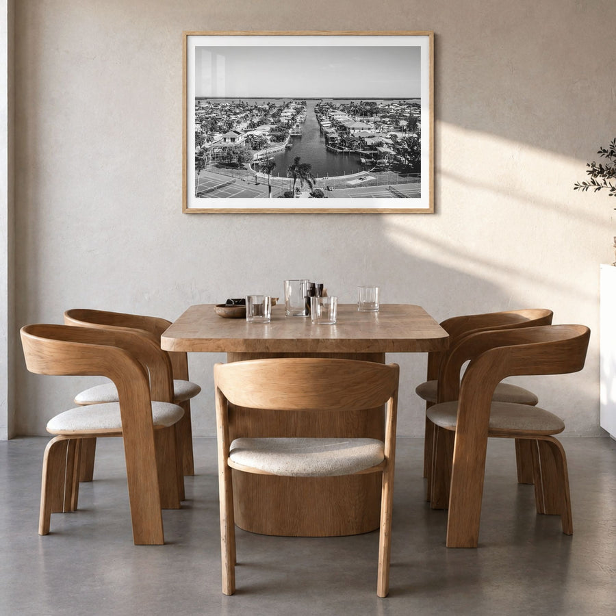 Fort Myers Photo Poster in a natural wood frame, hanging in a dining room, white border