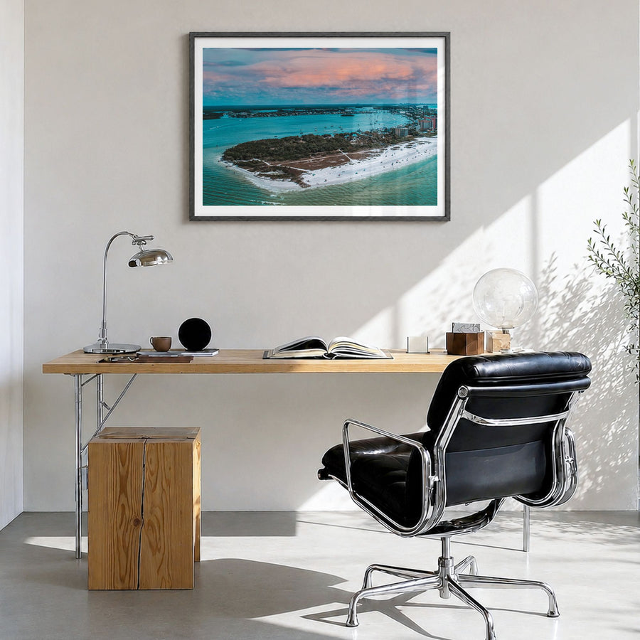 Fort Myers Photo Poster in a black wood frame, hanging in a bright home office, white border