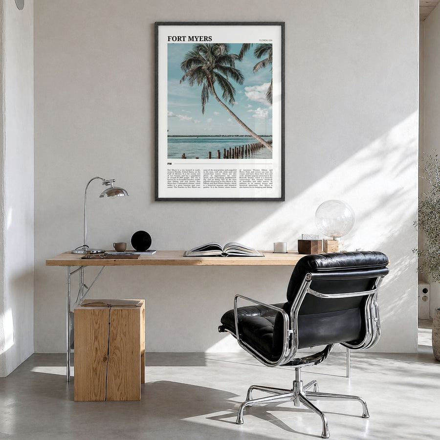 Fort Myers Travel Poster in a black wood frame, hanging in a bright home office