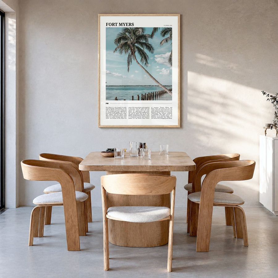 Fort Myers Travel Poster in a natural wood frame, hanging in a dining room