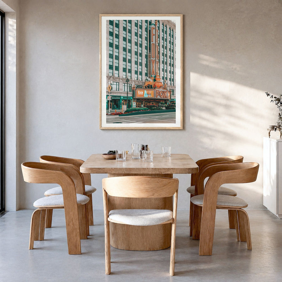 Fox Theater Photo Poster in a natural wood frame, hanging in a dining room, white border