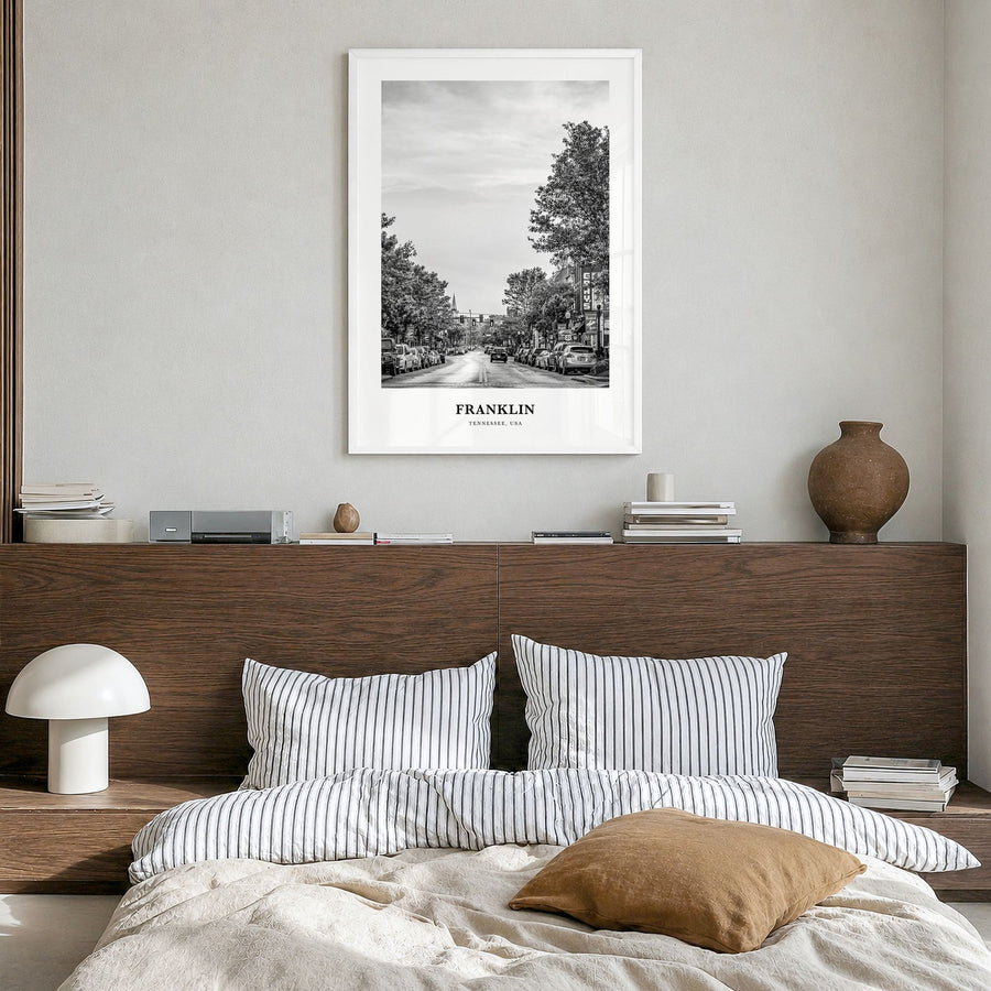 Franklin Classic Poster in a white wood frame, hanging in a bedroom